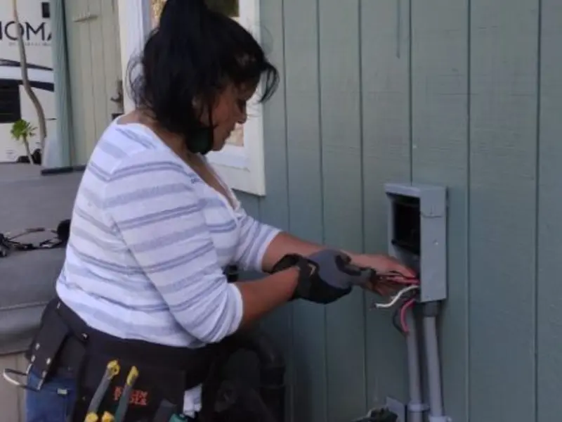 Licensed electrician wiring an exterior subpanel in Bluffton